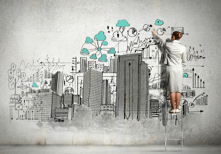 Businesswoman drawing on wall
